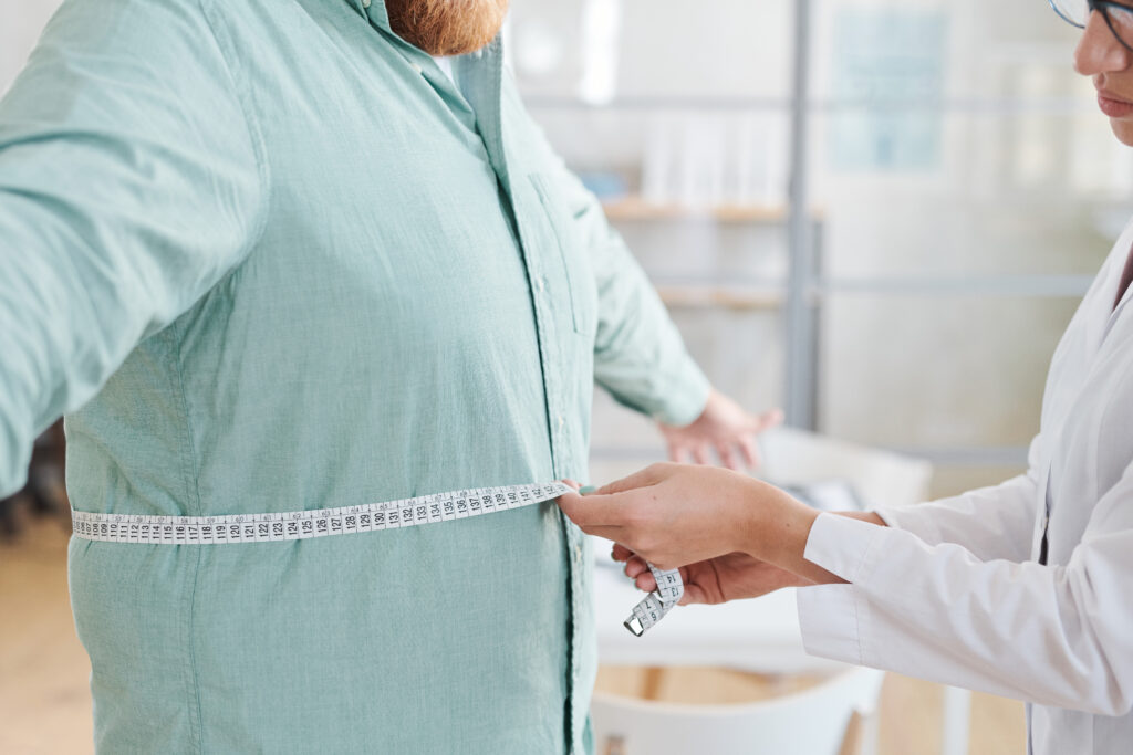 Bariatric surgery cost in Mexico - doctor measuring patient during consultation