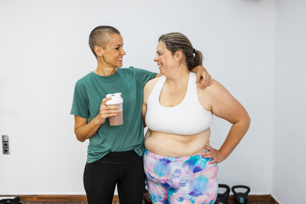 Endoscopic sleeve gastroplasty non-surgical weight loss - personal trainer supporting client with protein shake