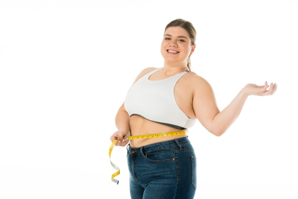 Gastric sleeve vs lap band - smiling woman measuring waist after successful weight loss surgery